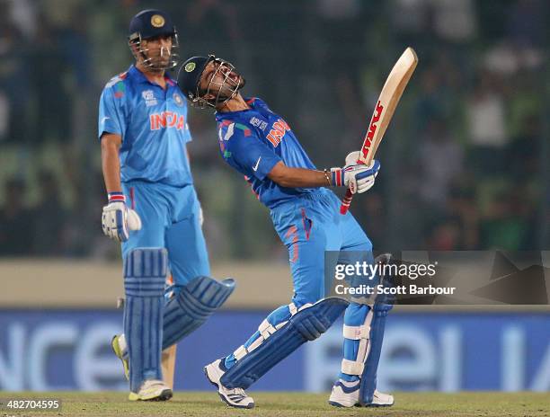 Virat Kohli of India screams after he hit the winning runs as MS Dhoni looks on as India win the ICC World Twenty20 Bangladesh 2014 2nd Semi-Final...