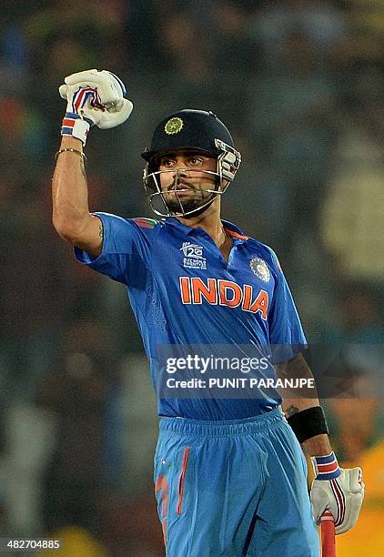 India batsman Virat Kohli celebrates after India won the ICC World Twenty20 cricket tournament second semi-final match against South Africa at The...