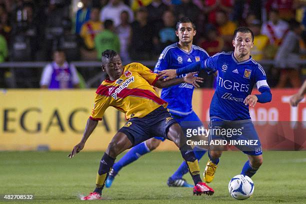Jefferson Cuero of Morelia vies for the ball with Jose Torres of Tigres, during their Mexican Apertura 2015 tournament football match at the Jose...