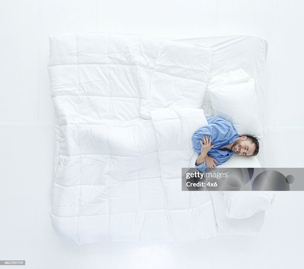 Top view of man sleeping on bed