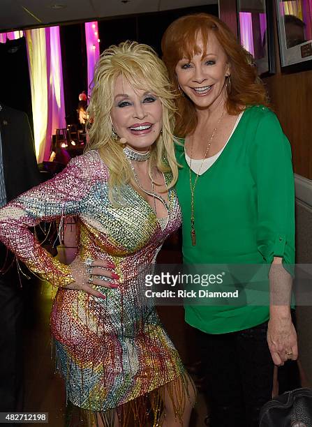 Reba McEntire visits Dolly Parton backstage during Dolly Parton: Pure & Simple Benefiting The Opry Trust Fund at Ryman Auditorium on August 1, 2015...