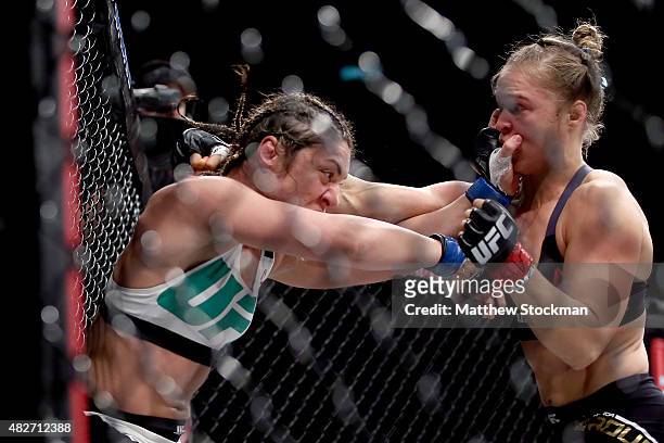 Ronda Rousey of the United States defeats Bethe Correia of Brazi l in their bantamweight title fight during the UFC 190 Rousey v Correia at HSBC...