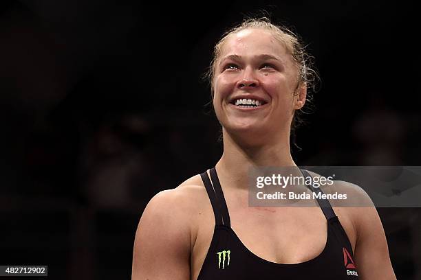 Ronda Rousey of the United States celebrates victory over Bethe Correia of Brazil in their bantamweight title fight during the UFC 190 Rousey v...