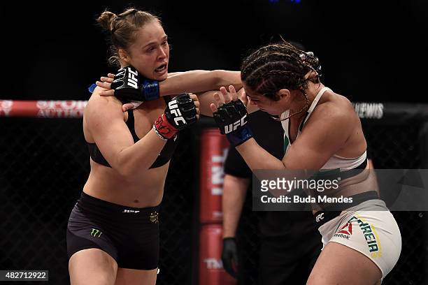 Ronda Rousey of the United States and Bethe Correia of Brazil exchange punches in their bantamweight title fight during the UFC 190 Rousey v Correia...