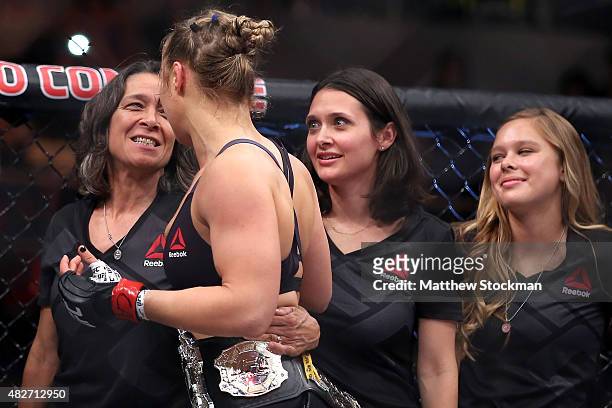 Ronda Rousey of the United States is congratulated by her mother, AnnMaria De Mars, after defeating Bethe Correia of Brazil in their bantamweight...