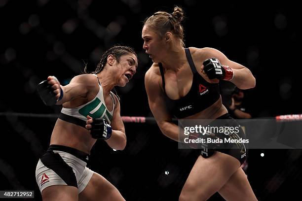 Ronda Rousey of the United States and Bethe Correia of Brazil exchange punches in their bantamweight title fight during the UFC 190 Rousey v Correia...