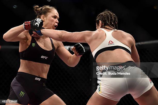 Ronda Rousey of the United States and Bethe Correia of Brazil exchange punches in their bantamweight title fight during the UFC 190 Rousey v Correia...