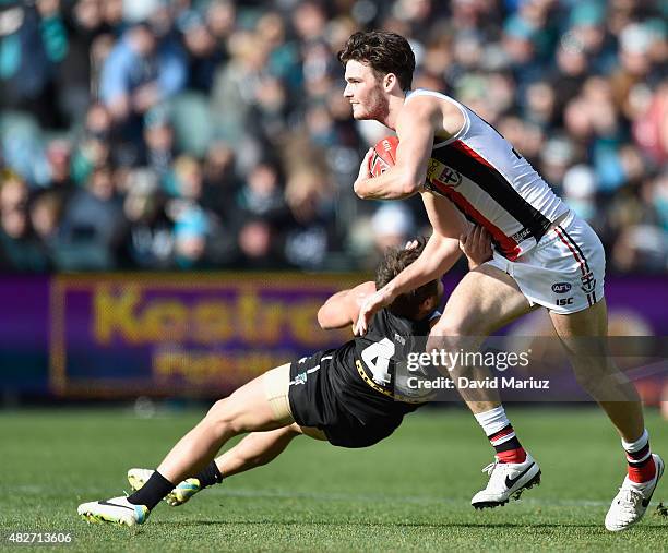 Dylan Roberton of the Saints stays clear of Sam Gray of the Power during the round 18 AFL match between the Port Adelaide Power and the St Kilda...