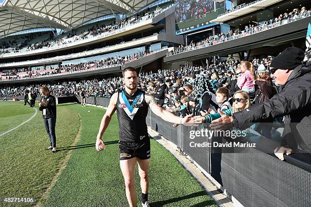 Travis Boak of the Power celebrates with the crowd after the round 18 AFL match between the Port Adelaide Power and the St Kilda Saints at Adelaide...