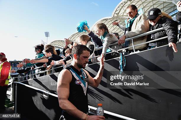 Travis Boak of the Power celebrates with the crowd after the round 18 AFL match between the Port Adelaide Power and the St Kilda Saints at Adelaide...