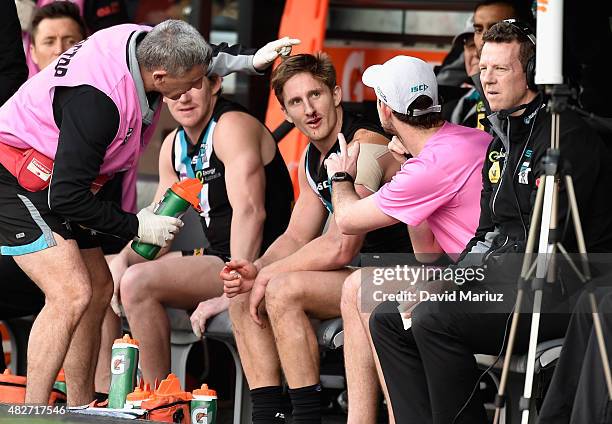 Hamish Hartlett of the Power is checked by physio's during the round 18 AFL match between the Port Adelaide Power and the St Kilda Saints at Adelaide...