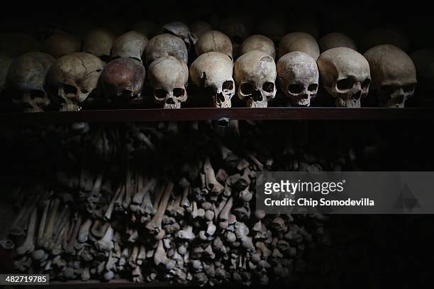 Metal racks hold the bones of thousands of genocide victims inside one of the crypts at the Nyamata Catholic Church memorial ahead of the 20th...