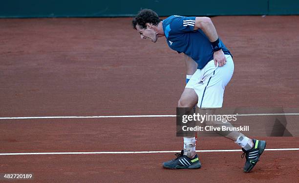 Andy Murray of Great Britain grabs his back after pulling up against Andreas Seppi of Italy during day one of the Davis Cup World Group Quarter Final...
