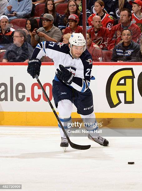 Eric Tangradi of the Winnipeg Jets skates with the puck against the Phoenix Coyotes at Jobing.com Arena on April 1, 2014 in Glendale, Arizona.