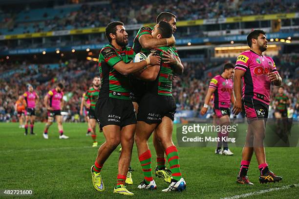Dylan Walker of the Rabbitohs celebrates with team mates after scoring a try during the round 21 NRL match between the South Sydney Rabbitohs and the...