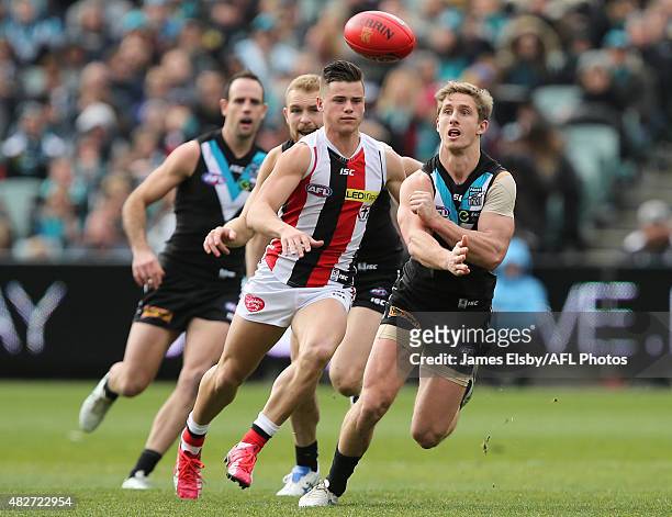 Jack Sinclair of the Saints chases Hamish Hartlett of the Power during the 2015 AFL round 18 match between Port Adelaide Power and the St Kilda...