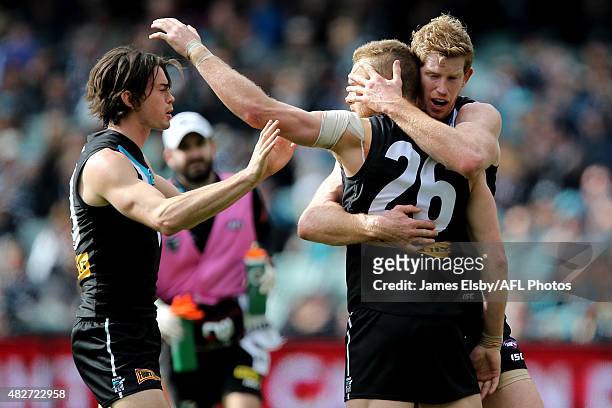 Jasper Pittard, Andrew Moore and Matthew Lobbe of the Power celebrate a goal during the 2015 AFL round 18 match between Port Adelaide Power and the...