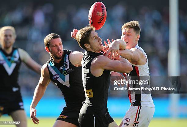 Travis Boak and Hamish Hartlett of the Power compete with Eli Templeton of the Saints during the 2015 AFL round 18 match between Port Adelaide Power...