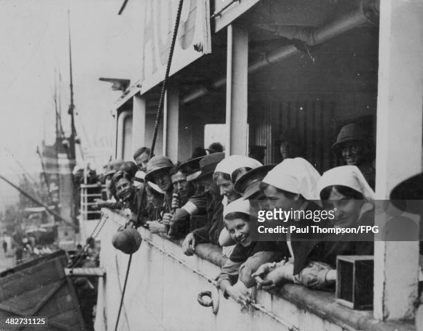 Wounded ANZAC soldiers during World War Two; happy to be returning home at Melbourne Docks, with the nurses who cared for them on the long journey,...