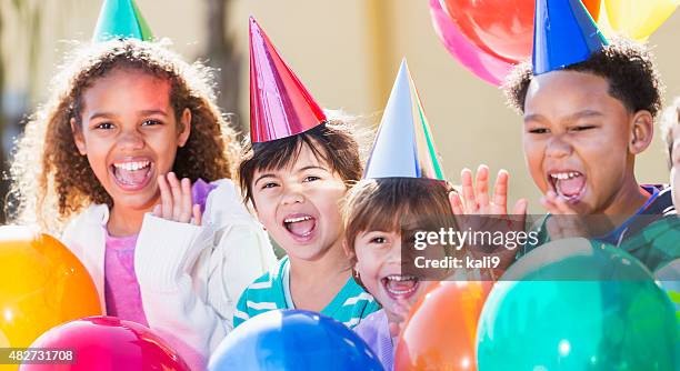 multiracial children at a birthday party - kids birthday stock pictures, royalty-free photos & images