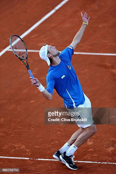 Andreas Seppi of Italy serves against Andy Murray of Great Britain during day one of the Davis Cup World Group Quarter Final match between Italy and...