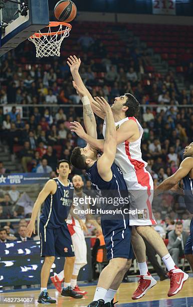 Giorgi Shermadini, #5 of Olympiacos Piraeus competes with Deniz Kilicli, #13 of Anadolu Efes Istanbul in action during the 2013-2014 Turkish Airlines...