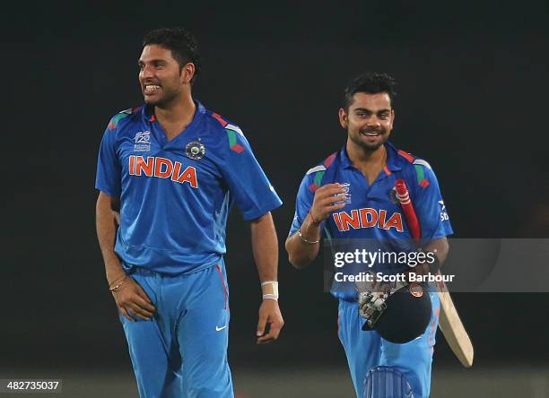 Virat Kohli of India and Yuvraj Singh celebrate after Kohli hit the winning runs as India won the ICC World Twenty20 Bangladesh 2014 2nd Semi-Final...