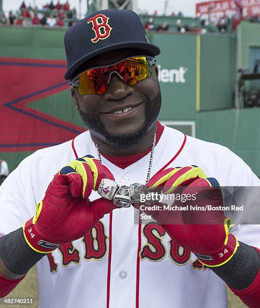 David Ortiz of the Boston Red Sox shows of his 2004, 2007 and 2013 championship rings along with a ring honoring his 2013 World Series MVP selection...