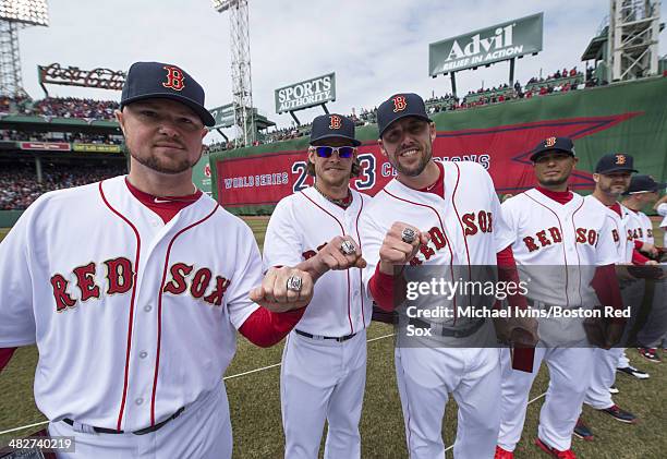 Pitchers Jon Lester, Clay Buchholz and John Lackey of the Boston Red Sox show off their 2013 championship rings during a ceremony honoring the 2013...