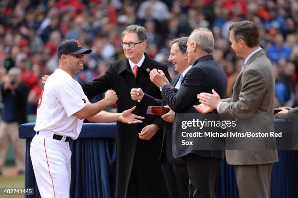 Shane Victorino of the Boston receives a championship ring from Principal Owner John W. Henry and Chairman Tom Werner during a ceremony honoring the...