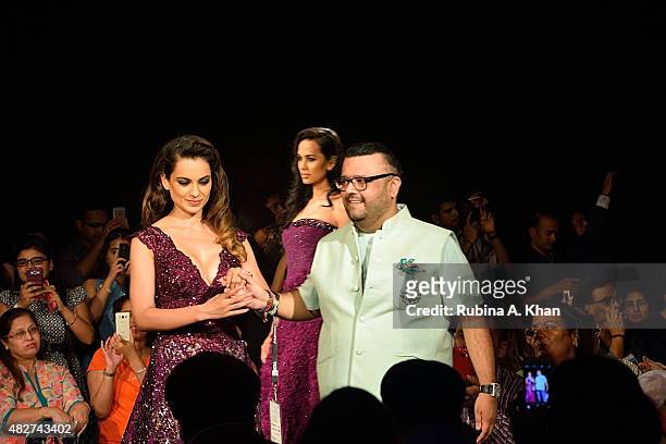 Bollywood actress Kangna Ranaut and designer Manav Gangwani walk the runway on the fifth and final day of the Fashion Design Council of India's...