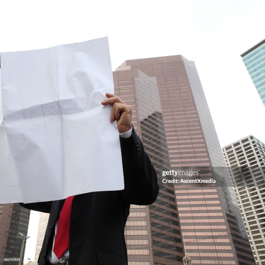 Businessman looking at architectural plans