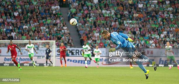 Goalkeeper Manuel Neuer of FC Bayern Muenchen saves a ball with a header during the DFL Supercup 2015 match between VfL Wolfsburg and FC Bayern...