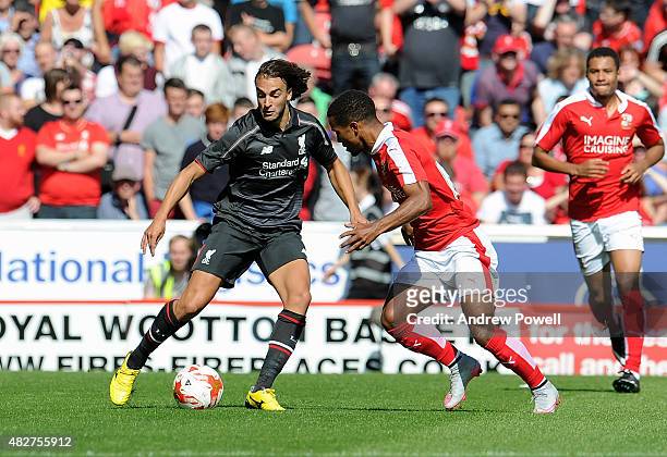 Lazar Markovic of Liverpool competes with Nathan Byrne of Swindon Town during a preseason friendly at County Ground on August 2, 2015 in Swindon,...