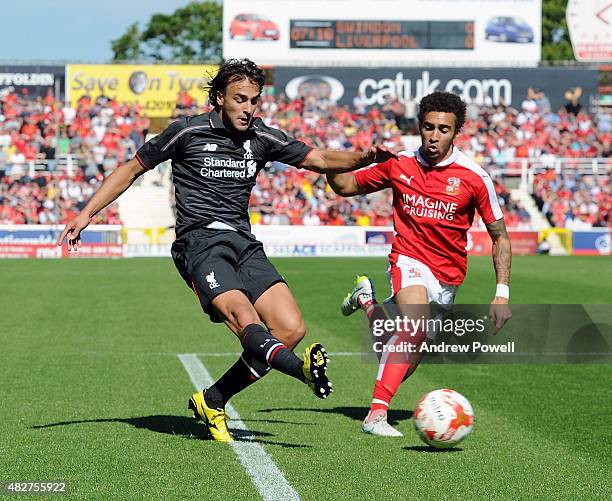 Lazar Markovic of Liverpool competes with Nathan Byrne of Swindon Town during a preseason friendly at County Ground on August 2, 2015 in Swindon,...