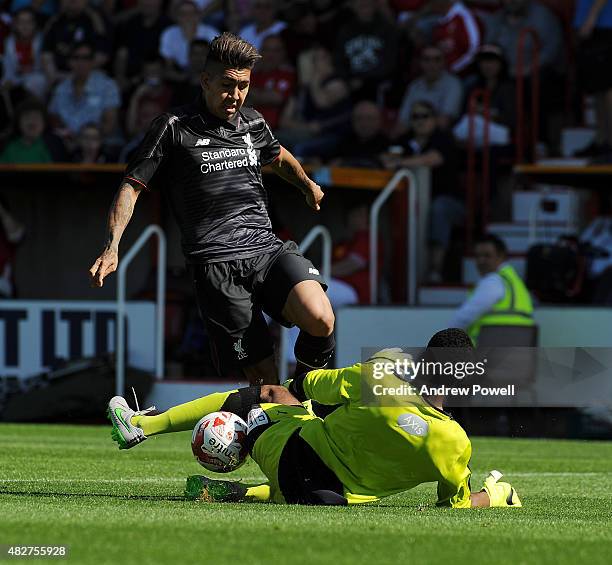 Roberto Firmino of Liverpool goes in on Lawrence Vigouroux of Swindon Town during a preseason friendly at County Ground on August 2, 2015 in Swindon,...