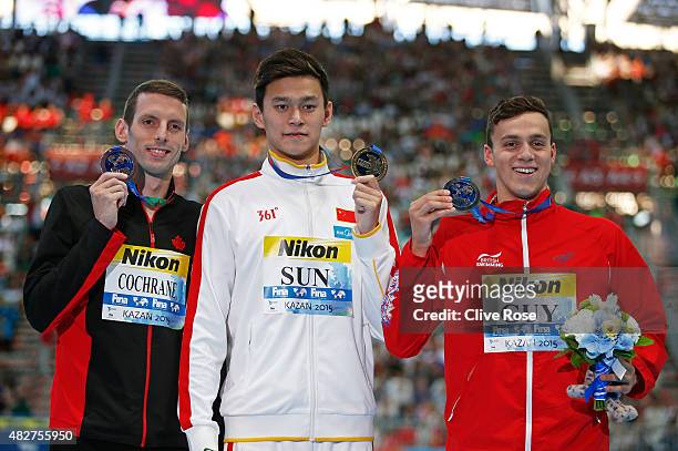 Gold medalist Yang Sun of China poses with silver medalist James Guy of Great Britain and bronze medalists Ryan Cochrane of Canada during the medal...