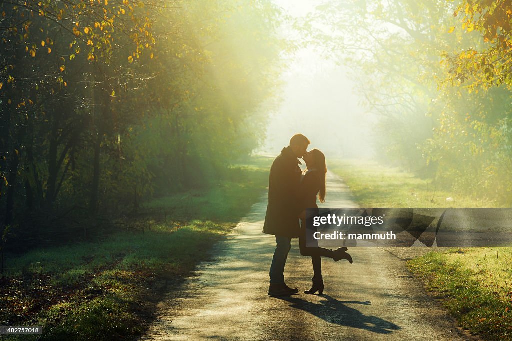 Young couple kissing in the sunshine