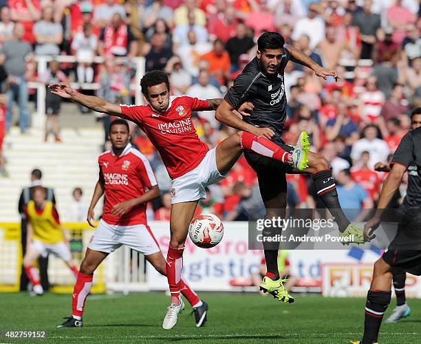 Emre Can of Liverpool goes up with Nathan Byrne of Swindon Town during a preseason friendly at County Ground on August 2, 2015 in Swindon, England.