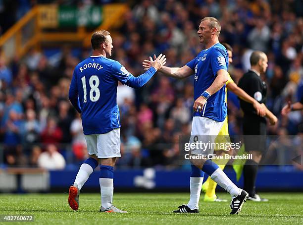 Wayne Rooney of Everton and Manchester United with Duncan Ferguson of Everton at the end of the Duncan Ferguson Testimonial match between Everton and...