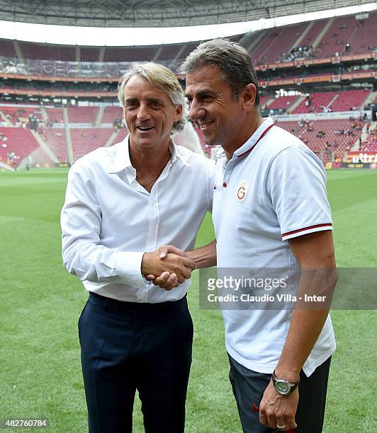 Head coach FC Internazionale Roberto Mancini and head coach Galatasaray AS Hamza Hamzaoglu attend before the preseason friendly match between...