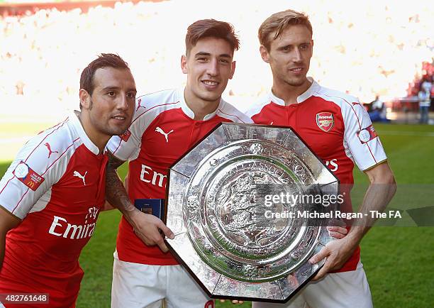 Santi Cazorla, Hector Bellerin and Nacho Monreal of Arsenal pose with the trophy after the FA Community Shield match between Chelsea and Arsenal at...