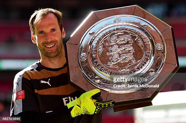Petr Cech of Arsenal poses for photographs with the trophy after his team's 1-0 win in the FA Community Shield match between Chelsea and Arsenal at...