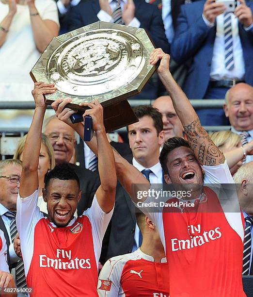 Francis Coquelin and Olivier Giroud of Arsenal lift the Community Shield after the FA Community Shield match between Chelsea and Arsenal at Wembley...
