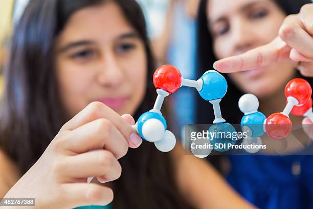 hispanic mother homeschooling preteen daughter, teaching science class - preteen model stock pictures, royalty-free photos & images