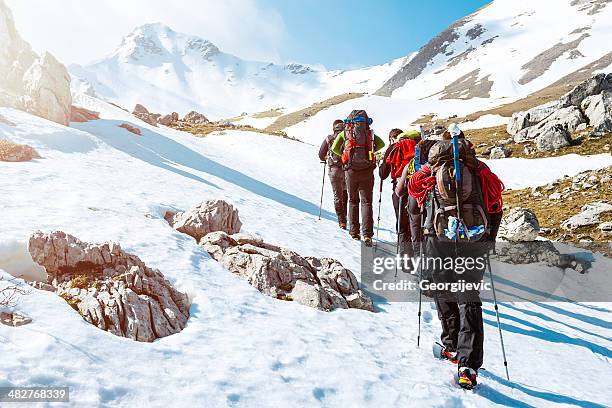 mountaineering - team climbing up to mountain top stock pictures, royalty-free photos & images