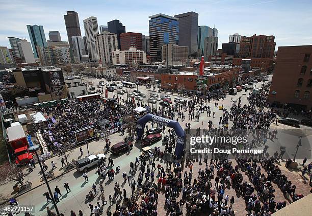 Fans flood the intersection of Blake Street and 20th Street as they head into the stadium to watch the Arizona Diamondbacks face the Colorado Rockies...