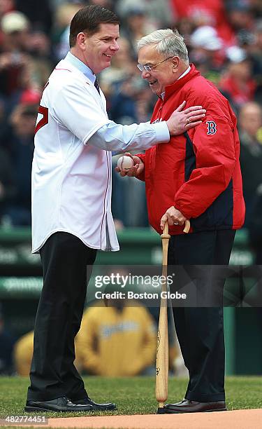 Boston mayor Martin Walsh, left, shares a moment with his predecessor Thomas Menino, right, on the field during pre-game ceremonies. Mayor Walsh...