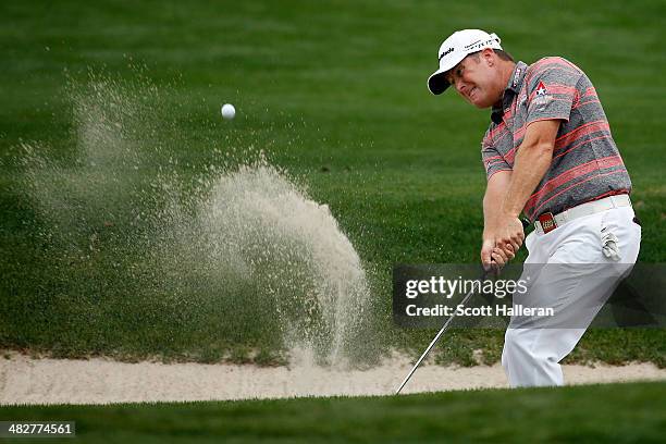 Points of the United States hits a shot out of the bunker on the eighth hole during round one of the Shell Houston Open at the Golf Club of Houston...