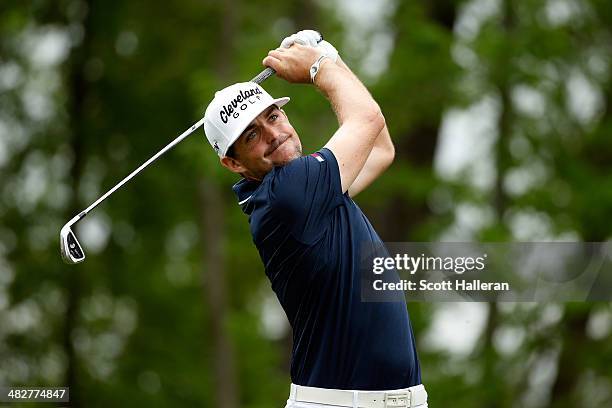 Keegan Bradley of the United States watches his tee shot on the ninth hole during round one of the Shell Houston Open at the Golf Club of Houston on...